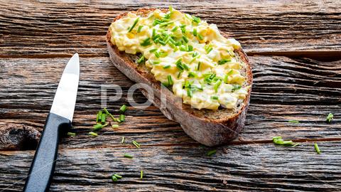 Bread with eggs salad and chives on rustick old wooden table with copy space background closeup copy space culinary delicious diet egg salad food fresh gourmet herb homemade hungry ingredient knife meal ready to eat rustic segg spread snack table tasty text space textured vegetarian wood wooden