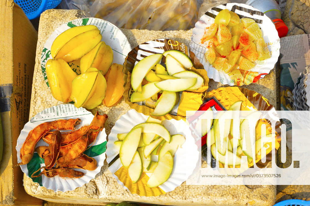 Sliced Konkani fruit like tamarind, amla or Indian gooseberry, raw mango and Star Fruit or Carambola for sale at Nagaon beach, Maharashtra, India, India Sliced Konkani fruit like tamarind, amla or Indian gooseberry, raw mango and Star Fruit or Carambola for sale at Nagaon beach, Maharashtra, India