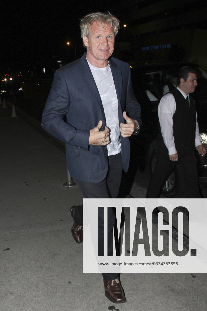 Chef Gordon Ramsay leaves BOA Steak House in West Hollywood after dining with friends 62774, LOS ANGELES, CALIFORNIA - Wednesday June 15th 2011. Chef Gordon Ramsay leaves BOA Steak House in West Hollywood - making a sad face and holding his stomach! This turned to smiles as he neared his waiting car, after dining with friends. , Credit:David Tonnessen Avalon USA, West Hollywood