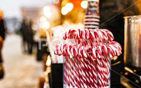 Traditional Christmas lollipop cane candies with red and white stripes at traditional street food festival market. Festive sweets at fair as symbol of Xmas candy cane street food red white sweet decoration christmas december holiday city present stylish market xmas design outdoor traditional american shop store eve year new celebration symbol outside gift lollipop merry shape town beautiful culture choose festive lovely striped fair happy
