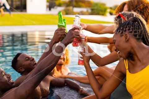Happy diverse group of friends having pool party, drinking beer and making a toast in garden. Lifestyle, friendship and party, summer, sunshine, unaltered. Medium Group Of People Young Adult Woman Female Black Multiracial Man Male Mid Adult White People Happy Diverse Group Friend Pool Party Drinking Beer Making Toast Garden Lifestyle Friendship Summer Sunshine Unaltered Young Beautiful Nature Fun Outdoor Person Spring Leisure Happiness Adult Beauty Smile Green Cheerful Together Plant Portrait Cute Vacation Diverse Group Pool Party Drinking Beer