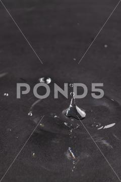 Close up of water drop falling into water with ripples and copy space on black background. Water, liquid and colour concept. No People Close Water Drop Falling Water Ripple Copy Space Black Background Liquid Colour Concept Drop Splash Abstract Design Background Wet Flow Fluid Closeup Illustration Wave Macro Business Graphic Symbol Flowing Isolated Color Drink Clean Water Falling Copy Space Black