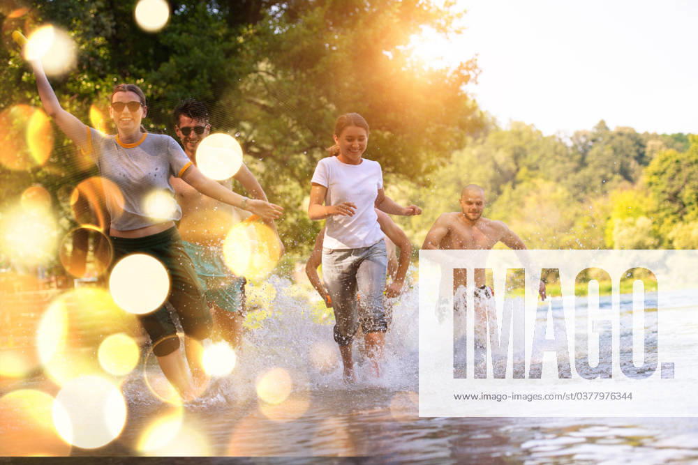 Summer joy friends having fun on river summer joy group of happy friends having fun while running and splashing on river ,model released, Symbolfoto