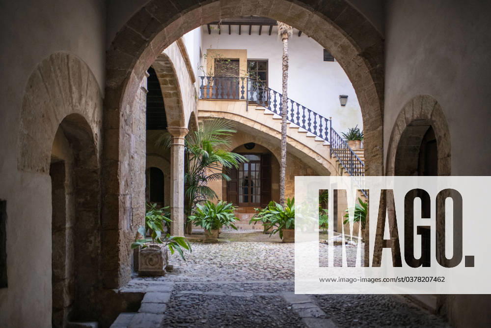 Spain Balearic islands Mallorca Palma de Mallorca Carrer de Can Savella stret Interior of some of the Majorcan patios Mallorca courtyard. Majorcan-style interior patios of some houses on Calle Can Savella. Can Vivot, declared an Asset of Cultural Interest and a Historic-Artistic Monument, has a spectacular stately courtyard populated by three vintage horse-drawn carriages. Behind this impressive entrance hides a no less surprising origin that dates back to the fourteenth century with the union of the raconada d en Berard and l alberg d en Clapà s, houses very close to each other. Prior to that, there is an Arab arch that, according to Montaner, is believed to be the roof of some baths. Mallorca Baleares Spain