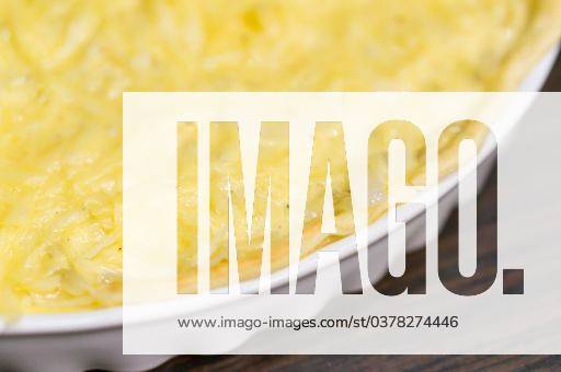 A soft focus shot of an onion tart in a white dish on a wooden table 260876 RECORD DATE NOT STATED