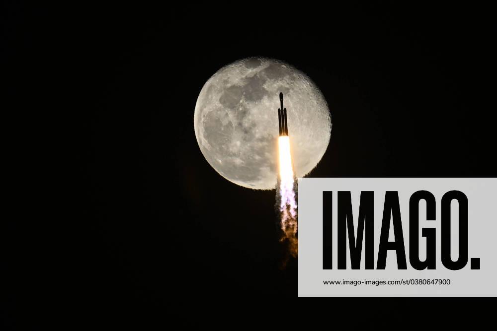 A SpaceX Falcon Heavy rocket flies past a near full moon as it launches the X37B at 8:07 PM for the United States Space Force from Launch Complex 39 at the Kennedy Space Center, Florida on Thursday, December 28, 2023. This is the seventh mission for the military space plane, but the first launched by SpaceX. KSP20231228015 JOExMARINO