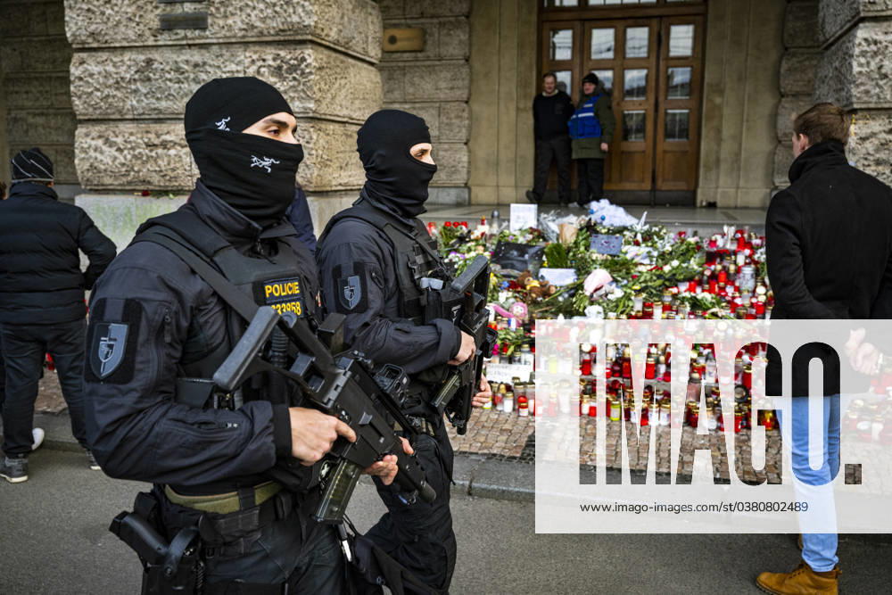 Armed police officers walk past a memorial for the victims of the shooting in front of the Faculty of Arts at Charles University, in Prague, Czech Republic, December 29, 2023. (CTKxPhoto RomanxVondrous) CTKPhotoP2023122904167 CTKPhotoP2023122904167