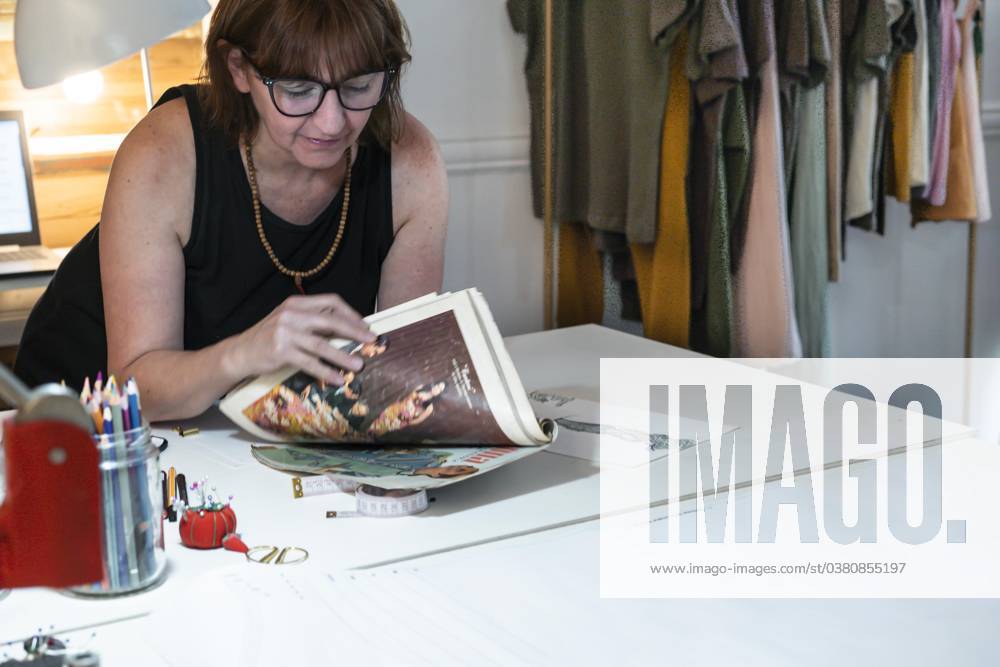 Mid Adult Fashion designer with View at a Fashion magazine