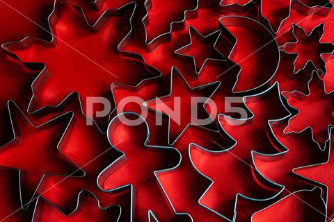 Top view of set of various cookie cutters located on red surface as symbol for Christmas holiday christmas cookie holiday symbol cutter set xmas new year various tradition festive celebrate shape element season event winter eve december greeting star occasion gingerbread object tree different form special creative biscuit culinary congratulate template detail assorted arrangement composition decorative advent red background layout top view overhead from above high angle