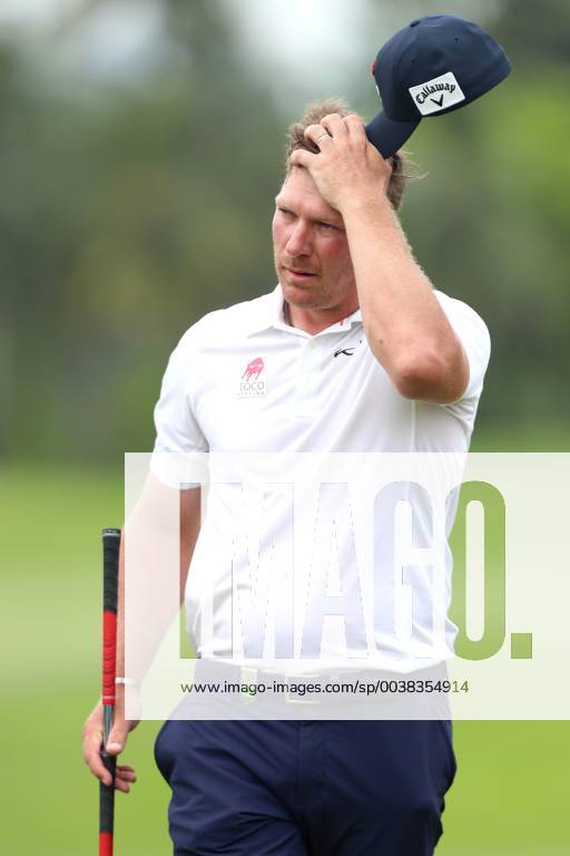 Singapore - Shaun Norris of South Africa adjusts his hat on the 9th hole during the second round of the Singapore Open at the Serapong Course, Sentosa Golf Club. Golf 2019: Singapore Open - Second Round - ZUMAm170 88556148st