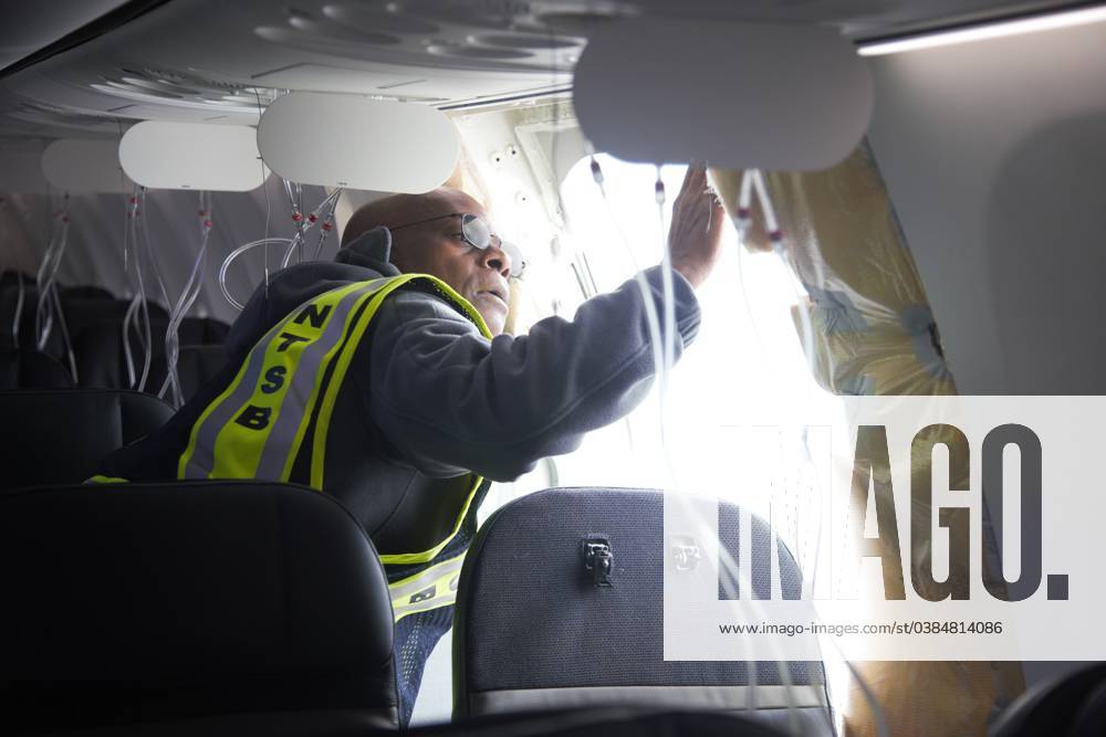 NTSB investigators examine the missing door plug section on Alaska Airlines Flight 1282, a Boeing 737-9 MAX commercial aircraft, January 7, 2024 in Portland, Oregon. The aircraft suffered a blowout of a door plug on January 5th resulting in uncontrolled decompression of the aircraft and forcing an emergency landing. Portland United States - ZUMAp138 20240108_zaa_p138_002
