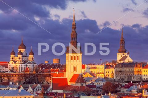 Scenic aerial view of the historic city center. Tallinn. Estonia. Tallinn Estonia Europe Baltika city towers architecture facades building domes medieval streets tourist attraction travel tourism square story dawn morning lanterns old roofs famous cityscape aerial view clouds