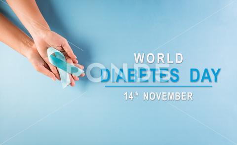 World diabetes day awareness concept. Hand holding blue ribbon, symbolic bow color raising awareness in diabetes day on pastel background, 14 November. analyzing awareness background blood care checking concept control day diabet diabetes diabetes concept diabetes test diabetic diagnosis disease drop finger glucometer glucose hand health health care healthcare healthy hospital hyperglycemia hypoglycemia illness instrument insulin insulin injection insulin pen level measure measurement medical medicine meter patient person prevention protection ribbon sample stick sugar test treatment world