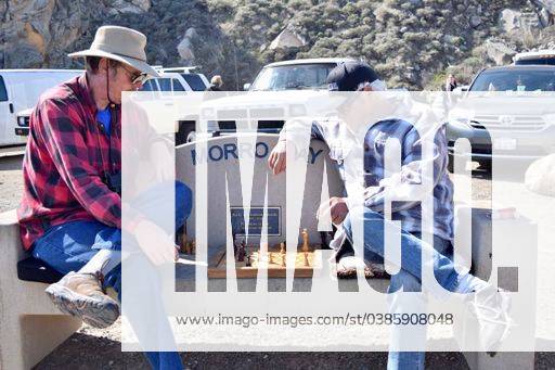 A photo of two men playing a Chess game outside on a bench in Morro Bay in Ca. March 2021 1827802