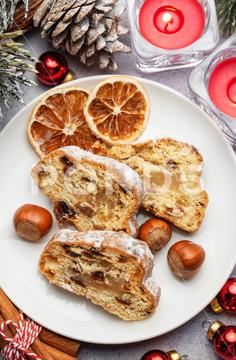 Traditional stollen fruit cake. Christmas stollen with winter holidays decoration. christmas stollen cake food bread homemade celebration bakery fruit winter spice cinnamon decoration raisin baked season advent holiday dessert fruitcake table rustic pastry slice tradition german icing baking marzipan sweet food biscuit brown sweet festive sugar fir tree home decor delicious traditional candle new year seasonal xmas december pie decor powder germany powdered