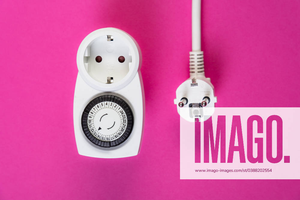 Timer with plug in front of a monochrome background Düsseldorf North Rhine-Westphalia Germany
