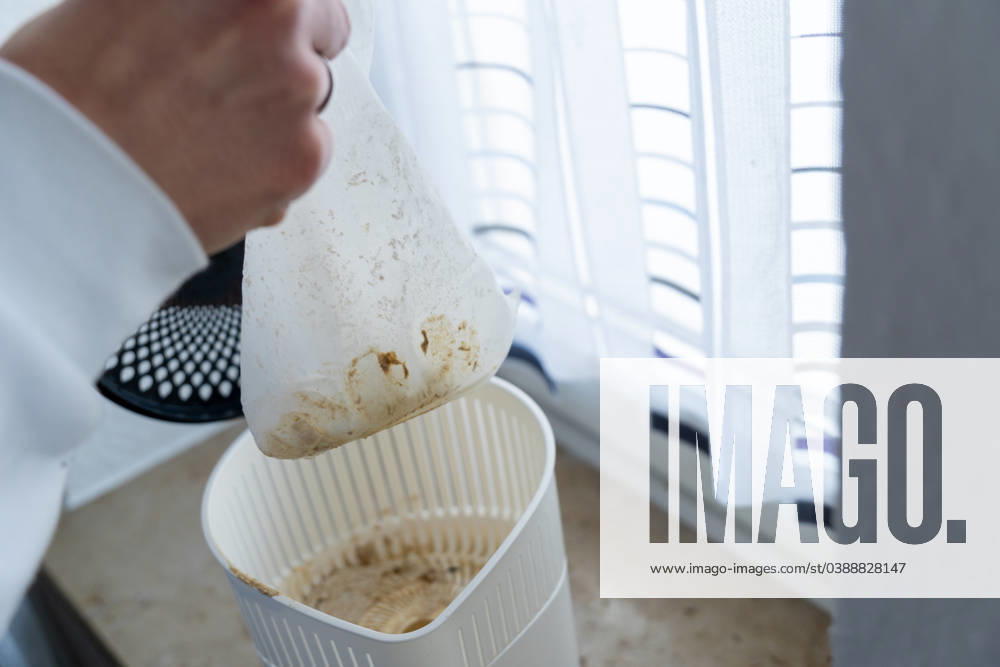 Man changes the granulate from a dehumidifier in an apartment