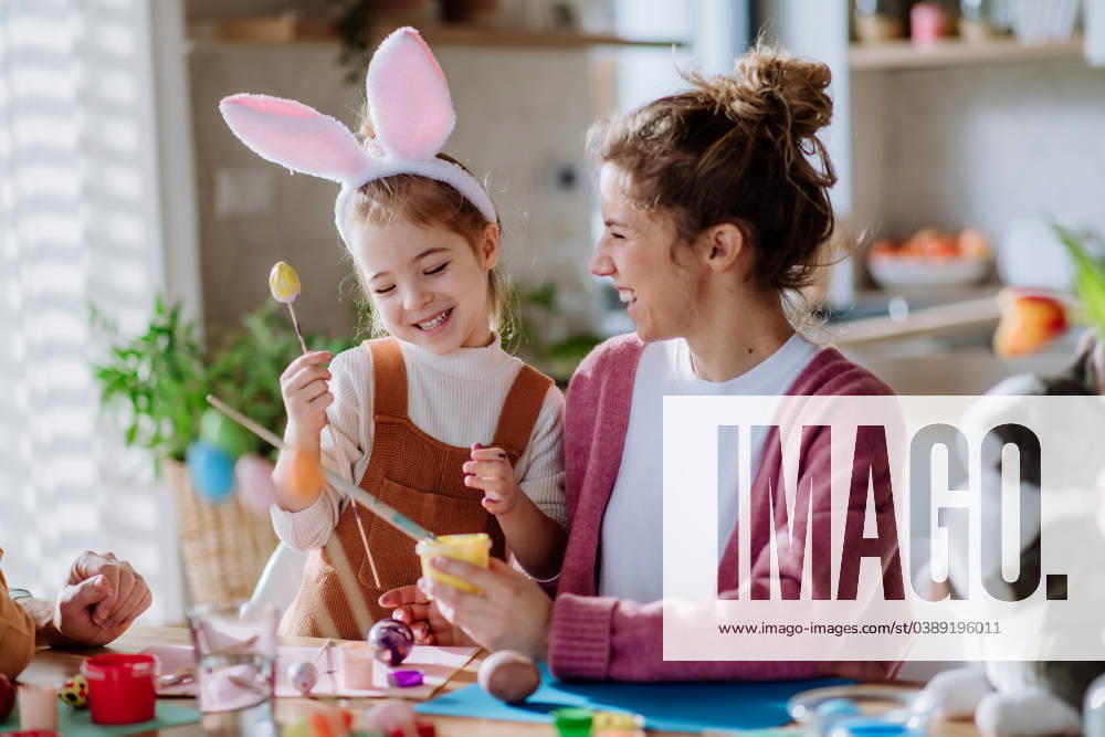Happy mother with her little daughter decorating easter eggs. Happy mother with her little daughter decorating easter eggs in their home. model released