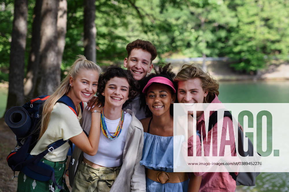 Group of young friends on camping trip near lake in summer. Portrait of group of young friends on camping trip near lake in summer. model released