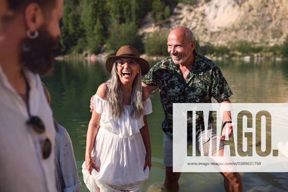Happy multigeneration family on summer holiday, having fun by lake. Portrait of happy multigeneration family on summer holiday, having fun by lake. model released