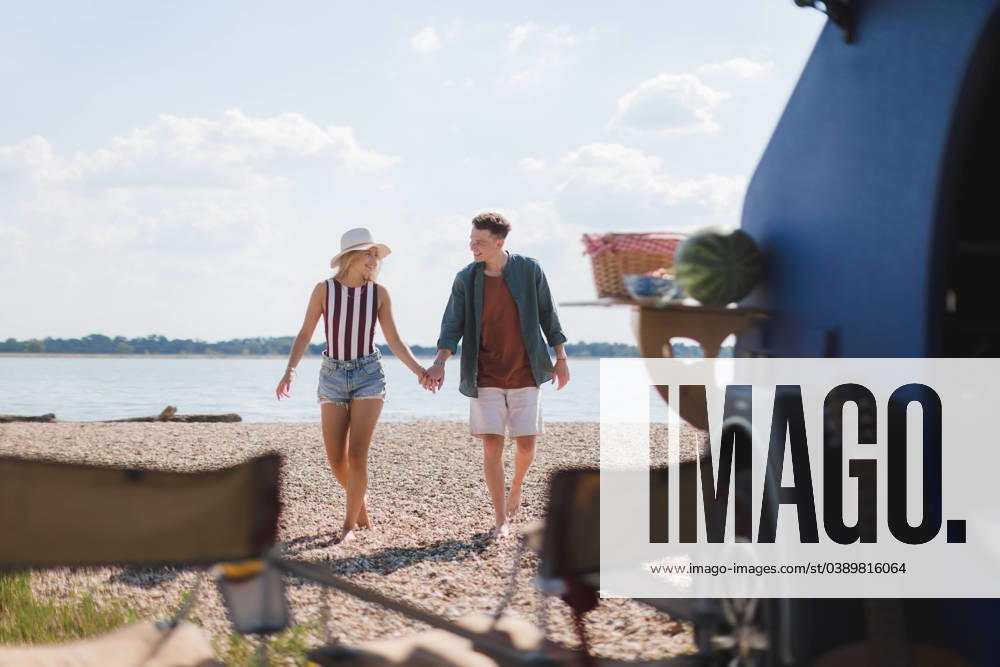 Young couple in front of van during summer vacation. Young couple in front of van during summer holiday. model released