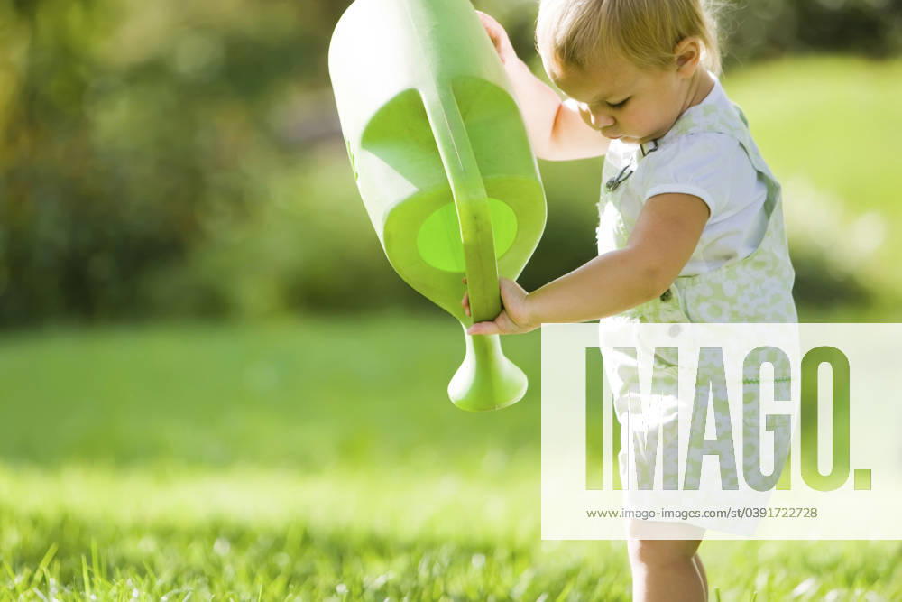 Caucasian baby lifting watering can St Louis, Missouri, United States, 21.12.2023, model released, TTBB_BLD095246.jpg, 12-17 months, baby, baby girl, baby girls, blonde hair, caucasian, childhood, color image, copy space, day, focus on foreground, gardening, grass, growth, holding, horizontal, innocence, looking down, nature, one person, outdoors, people, photography, side view, spring, standing, summer, three quarter length, watering, watering can,advancement, blond, child, children, color, colour, daylight, daytime, development, garden, gardener, girl, horticulture, human, human being, juvenile, kid, midsummer, natural, negative space, one, outdoor, outside, person, plant, spring like, spring-like, springlike, springtime, summertime, thr