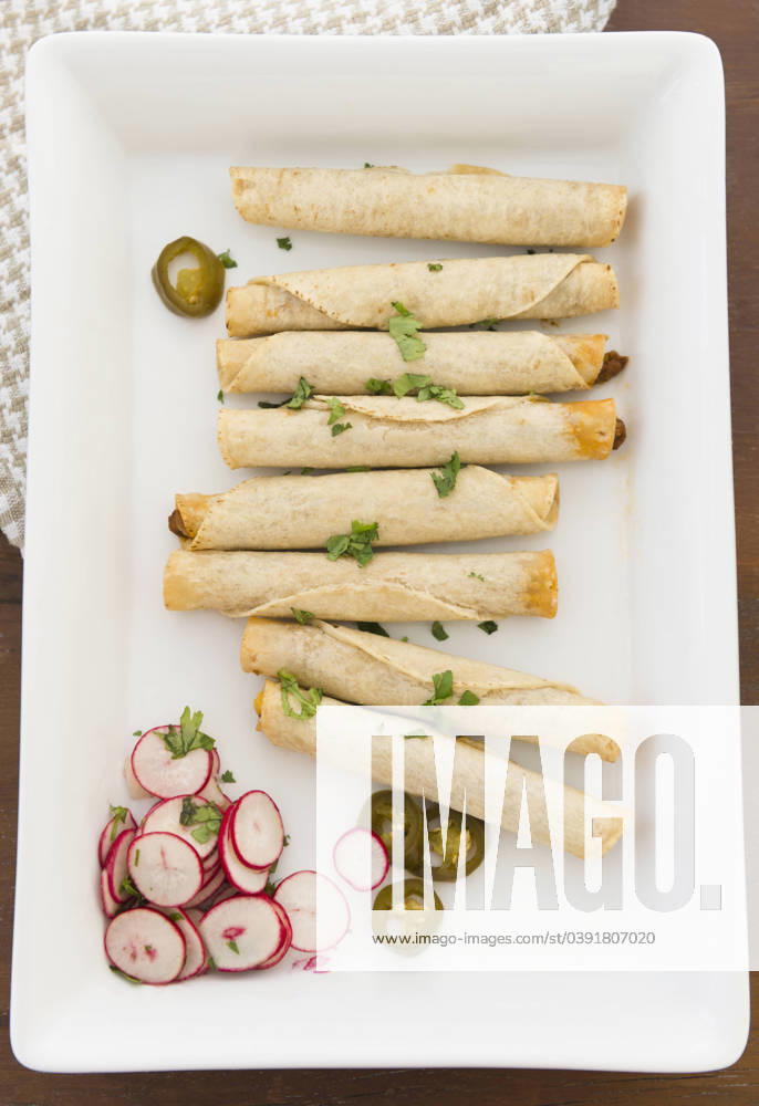 IMAGO Creative, Food, Taquitos Mexican taquitos on platter Jersey City, New Jersey, USA, 04.05.2012, TTBB_BLD103782.jpg, appetizer, color image, food and drink, freshness, garnish, high angle view, indoors, jalapeno, medium group of objects, mexican food, nobody, nourishing, nutrition, photography, platter, radish, rolled up, snack, still life, taquito, traditional cuisine, vertical, appetiser, color, colour, crockery, dish, dishware, food, fresh, group, health, healthy, high angle, hors doeuvre, indoor, inside, morsel, nourishment, nutritious, nutritive, refreshment, still-life, tableware, tidbit, vegetable, wholesome,