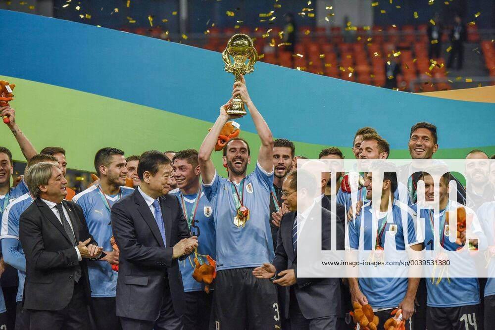KW13 NANNING, CHINA - MARCH 25: Diego Godin 3 of Uruguay holds the trophy during the award ceremony after 2019 China Cup International Football Championship between Uruguay and Thailand at Guangxi Sports Center on March 25, 2019 in Nanning, Guangxi Zhuang Autonomous Region of China.