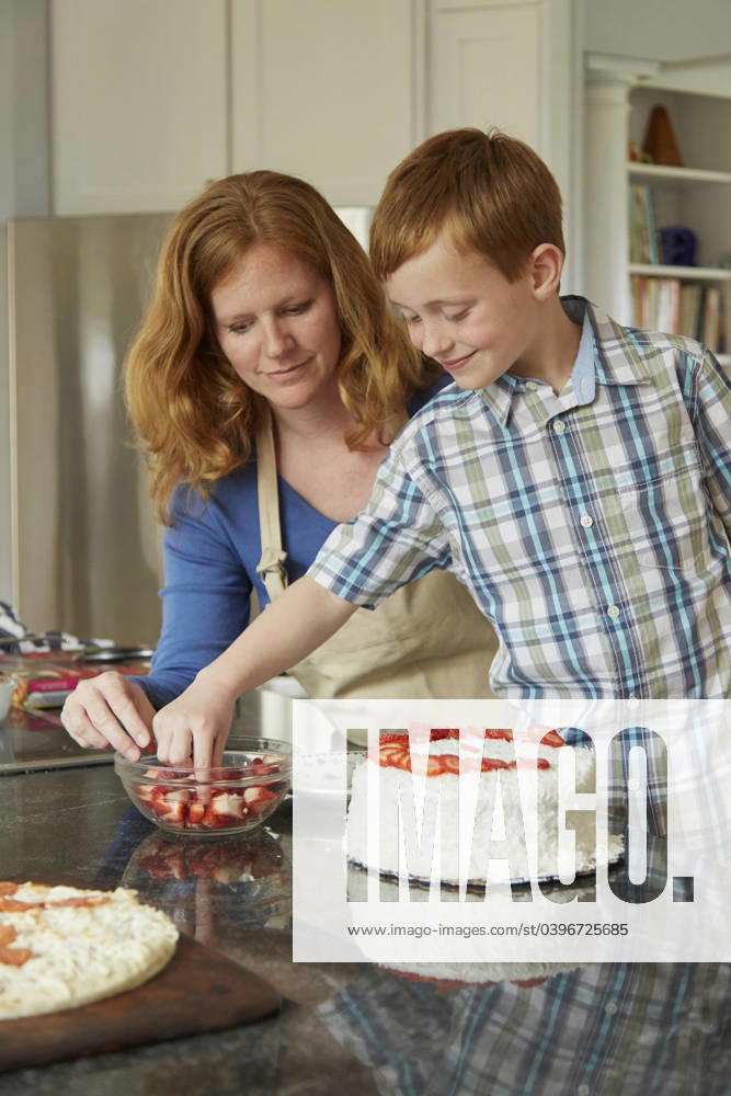 Caucasian mother and son decorating cake in kitchen Christiansburg, Virginia, USA, 07.04.2015, model released, TTBB_BLD158590.jpg, 40-44 years, 6-7 years, assistance, baking, bonding, boy, boys, cake, caucasian, childhood, choice, Christiansburg, color image, cooking, cooperation, decorating, dessert, domestic kitchen, domestic life, elementary age, family with one child, food and drink, happy, helping, indoors, learning, looking down, love, mature adult, mature women, mother, one parent, people, photography, red hair, selective focus, smiling, son, standing, strawberry, teaching, teamwork, together, two people, United States, vertical, Virginia, woman, working together, 2, 40-45, 40-50, 40s, 40s, 45-50, 50-55, 50-60, 55-60, adoring, adorn