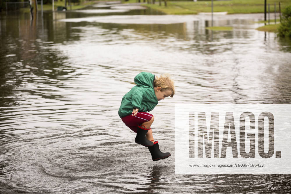 Caucasian boy jumping in puddle Norfolk, Virginia, USA, 02.10.2015, model released, TTBB_BLD188006.jpg, 2-3 years, active, alone, authentic, authenticity, blonde hair, blurred motion, boy, boys, candid, casual clothing, caucasian, childhood, color image, day, decisive moment, disaster, flooding, full length, happy, horizontal, jumping, looking down, motion, nature, norfolk, one person, outdoors, people, photography, playing, preschooler, puddle, real people, recreation, resilience, rising, rubber boot, sea level, side view, storm, united states, virginia, wellingtons, real lifeaccessory, action, adversity, america, american, americas, amusement, apparel, ascending, blond, blurry, calamity, catastrophe, cheerful, child, children, clothes, c