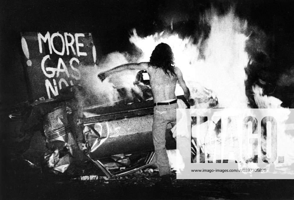 Gas Shortage Demonstrator in Front of Burning Car During Riot at Night, Levittown, Pennsylvania, USA, 1979
