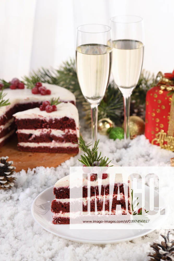 Piece of Red Velvet Cake Red Velvet Cake is a traditional red chocolate cake topped with white buttercream and decorated with a Christmas wreath of candied cranberries and rosemary.