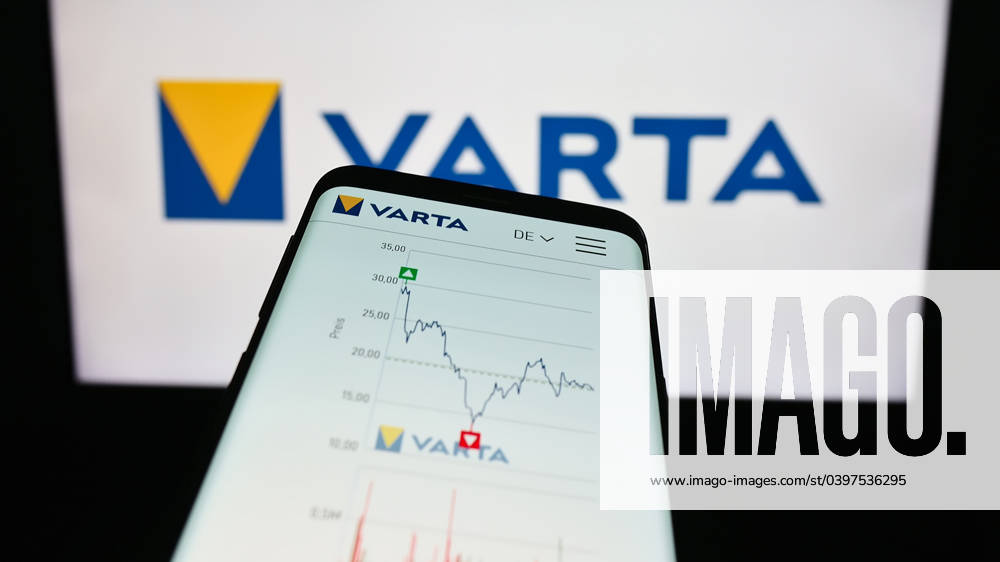Smartphone with website of German battery company Varta AG on screen in front of business logo. Stuttgart, Germany - 09-11-2023: Smartphone with website of German battery company Varta AG on screen in front of business logo. Focus on top-left of phone display.