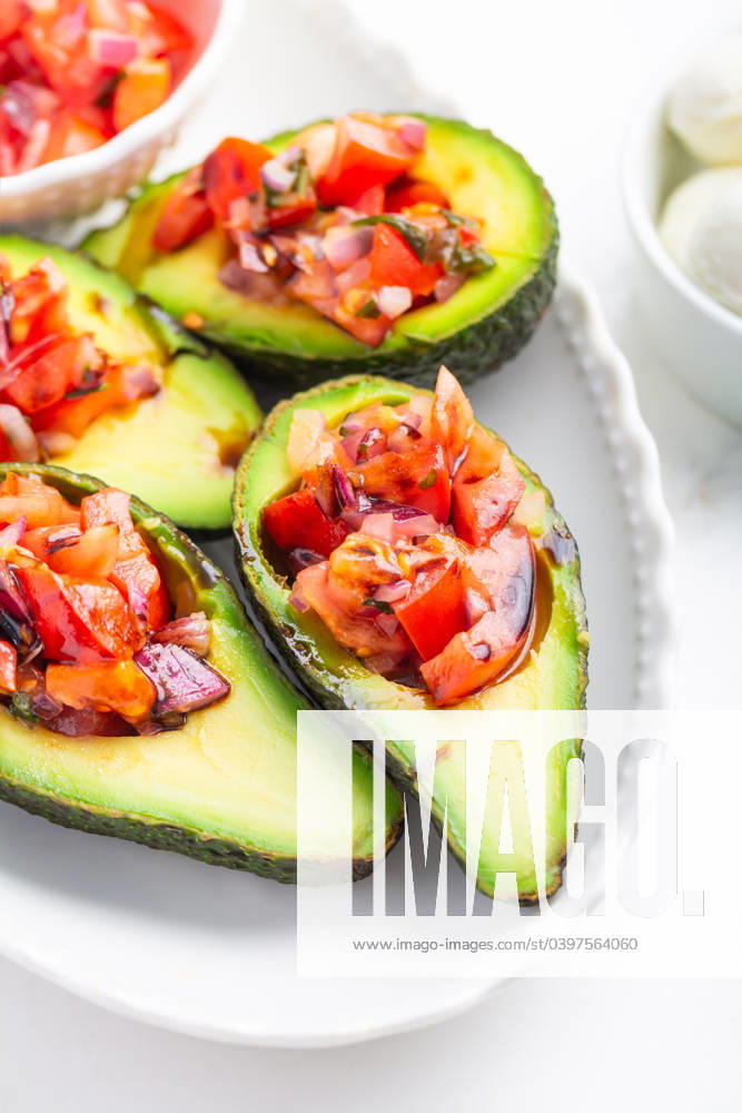 Avocados filled with bruschetta and balsamic vinaigrette - vegan appetizers Avocados filled with bruschetta and balsamic vinaigrette - vegan appetizers