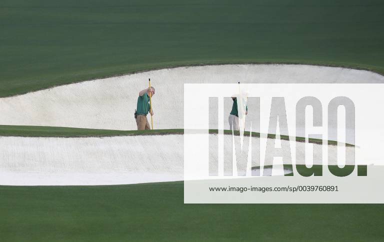 Workers rake a sand trap on the Monday before the 2019 Masters Tournament at Augusta National Golf Club in Augusta, Georgia, on April 8, 2019. AUG20190408101 JOHNxANGELILLO