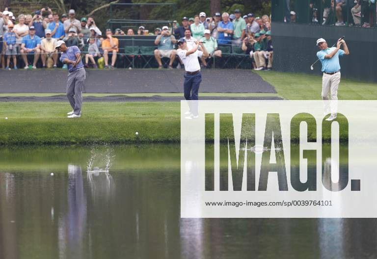 Tiger Woods, Justin Thomas and Fred Couples skip balls across the water on the 16th green when they practice on the Monday before the 2019 Masters Tournament at Augusta National Golf Club in Augusta, Georgia, on April 8, 2019. AUG20190408109 JOHNxANGELILLO