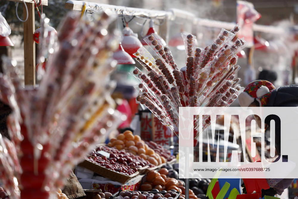A vendor sells ice-sugar gourd at the China Snow Town scenic area on January 24, 2024 in Mudanjiang, Heilongjiang Province of China.