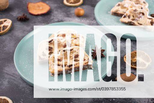 Christstollen, traditonal christmas cake with nuts, raisons, marzipan on a textured background, empty space for text 2773281 RECORD DATE NOT STATED