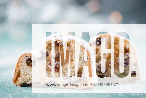 Christstollen, traditonal christmas cake with nuts, raisons, marzipan on a blue background, empty space for text 2773513 RECORD DATE NOT STATED