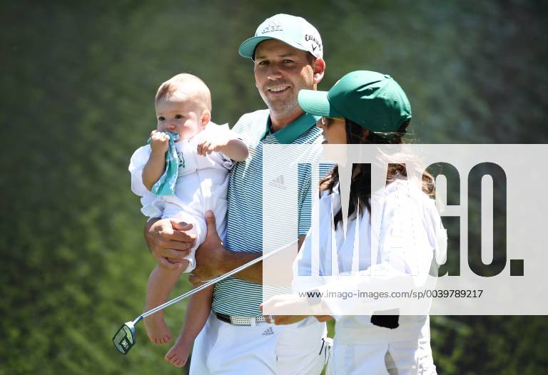 Sergio Garcia of Spain holds daughter Azalea Adele Garcia while walking with Angela Akins Garcia at the Par 3 Contest on the Wednesday before the 2019 Masters Tournament at Augusta National Golf Club in Augusta, Georgia, on April 10, 2019. AUG20190410914 KEVINxDIETSCH