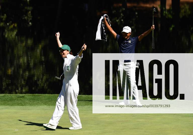 Satoshi Kodaira celebrates with his caddie when she makes a putt at the Par 3 Contest on the Wednesday before the 2019 Masters Tournament at Augusta National Golf Club in Augusta, Georgia, on April 10, 2019. AUG20190410926 KEVINxDIETSCH