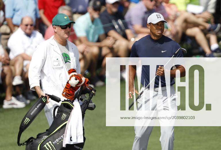 Tiger Woods holds a putter standing next to Joe LaCava on the 2nd hole in the first round at the 2019 Masters Tournament at Augusta National Golf Club in Augusta, Georgia, on April 11, 2019. AUG20190411138 JOHNxANGELILLO