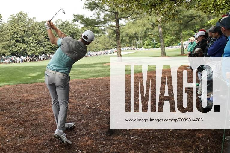 Dustin Johnson hits out of the pine straw with his 2nd shot on the first hole in the second round at the 2019 Masters Tournament at Augusta National Golf Club in Augusta, Georgia, on April 12, 2019. AUG20190412105 JOHNxANGELILLO