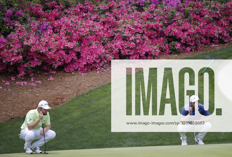 Francesco Molinari of Italy and Tyrrell Hatton line up putts on the 13th hole in the second round at the 2019 Masters Tournament at Augusta National Golf Club in Augusta, Georgia, on April 12, 2019. AUG20190412126 JOHNxANGELILLO