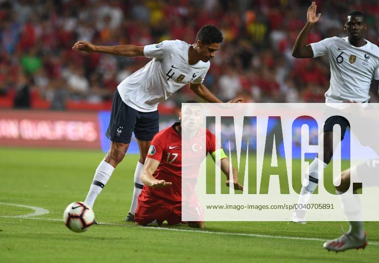 Frances Raphael Varane and Turkeys Burak Yilmaz during Euro 2020 group H qualifying soccer match between Turkey and France at the Konya City Stadium in Konya, Turkey
