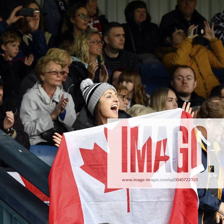 9th June 2019, Heywood Road stadium, Sale, Greater Manchester, England; Betfred Rugby Championship, Swinton versus Toronto Wolfpack; A Toronto Wolfpack fan waves her Canadian flag while enjoying the game at Swinton Lions ActionPlus12142752 SimonxWhitehead