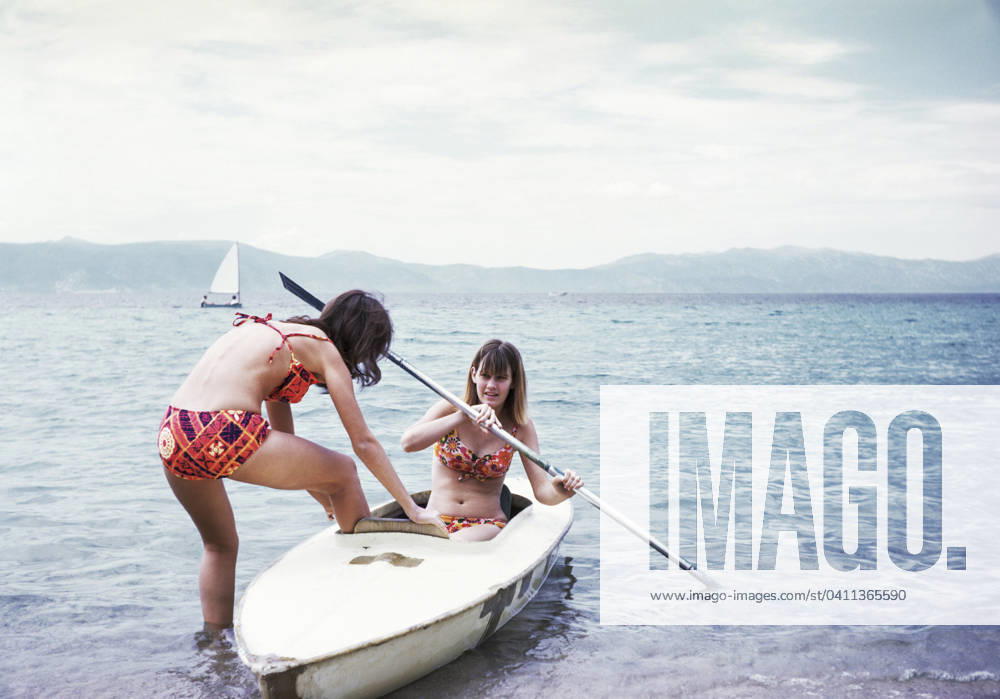 Caucasian girls in kayak on lake Lake Tahoe, California, United States, 29.02.2012, model released, TTBB_BLD246778.jpg, 12-13 years, 16-17 years, adventure, authentic, authenticity, bikini, brunette, california, candid, caucasian, childhood, cloud, color image, copy space, day, enjoyment, escape, friend, fun, gen z, generation z, getting away from it all, girl, girls, holding, holiday, horizontal, journey, kayak, kayaking, lake, lake tahoe, leisure activity, nature, nostalgia, ocean, old-fashioned, outdoors, people, photography, pre-adolescent child, real people, recreation, retro, seascape, selective focus, sister, sitting, sports, standing, summer, sunny, teamwork, teenage girl, teenage girls, teenager, three quarter length, together, tr