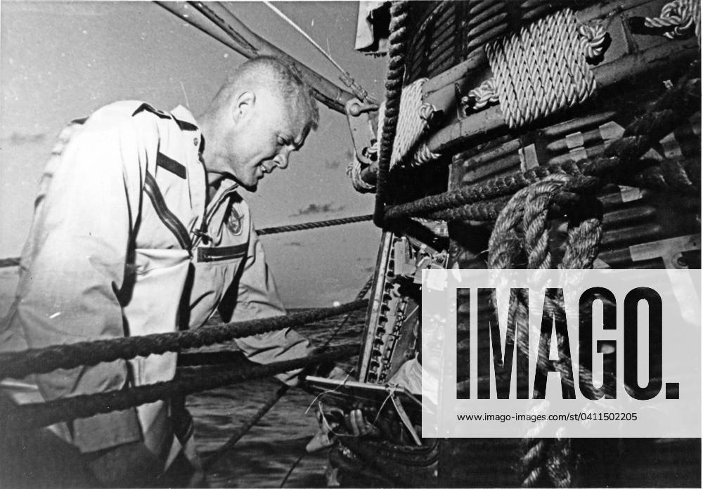 Glenn Inspects Friendship 7 Astronaut John H. Glenn, Jr. checks the Friendship 7 spacecraft after completing three orbits around the Earth, traveling at 17,500 miles per hour on February 20, 1962. The destroyer Noa picked-up Glenn and the spacecraft 21 minutes after landing near Grand Turk Island. A capsule technician inside the spacecraft checks the interior for any damage. Credit: NASA via CNP At Sea Aboard the USS NOA United States of America