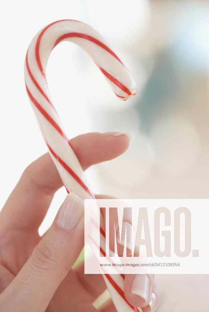 Close-up of woman holding candy cane , 12.01.2006, model released, TTBB_ti0124626.jpg, candy, candy cane, caucasian, christmas, close up, color image, finger, hand, holding, holiday, one person, only women, people, photography, striped, studio shot, vertical, woman, close-up, color, colour, female, hold, one, patterned, person, studio, sweet, vacationing, western european, xmas, ti0124626