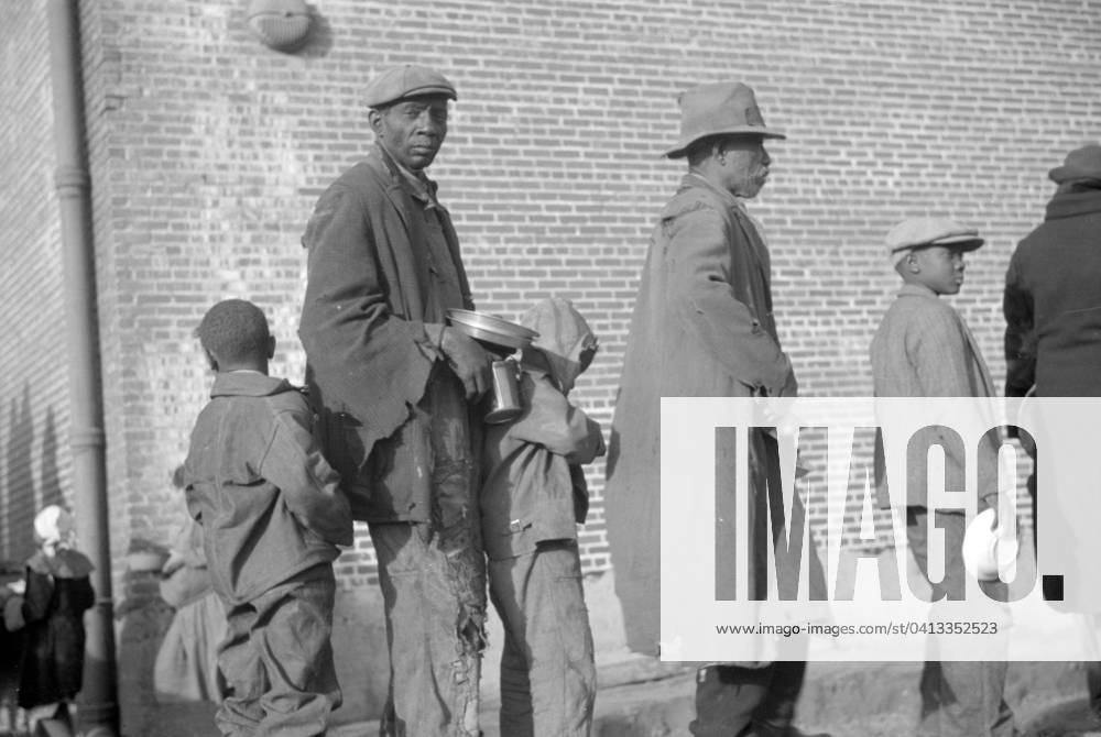 African Americans in the lineup for food at mealtime in the flood refugee camp, Forrest City, Arkansas 3666436 African Americans in the lineup for food at mealtime in the flood refugee camp, Forrest City, Arkansas by Evans, Walker (1903-75); Private Collection; (add.info.: Photograph taken for the U.S. Resettlement Administration: a New Deal U.S. federal agency that, between April 1935 and December 1936, relocated struggling urban and rural families to communities planned by the federal government.).